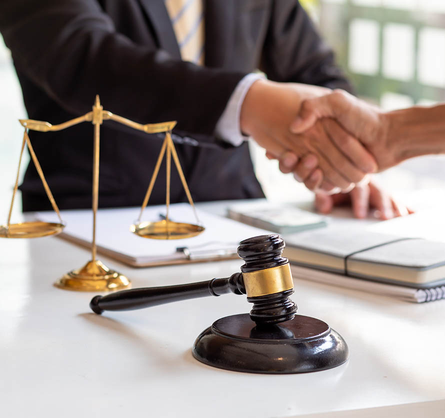 a lawyer shaking the hand of a client after a bankruptcy discharge